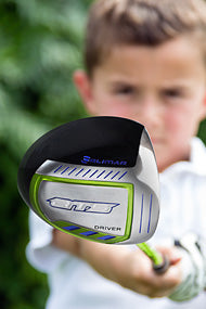 focused young junior golfer holding an Orlimar junior driver in front of him