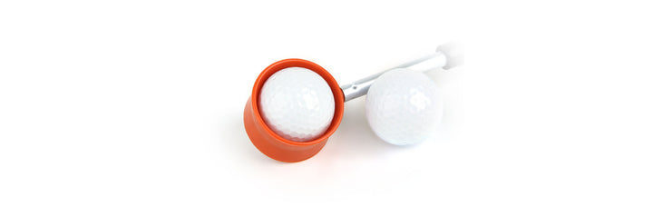 white golf bal next to an lOrlimar Fluorescent Head Golf Ball Retriever with a white golf ball in the orange ring