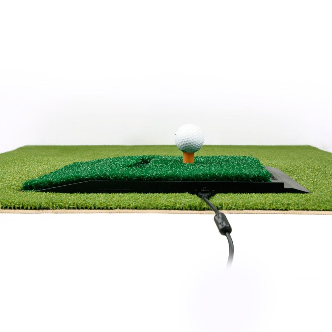 ground level view of the Optishot 2 In-Home Golf Simulator base inside the pre-cut hole in an Orlimar Golf Mat
