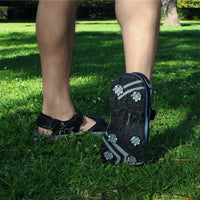man wearing a pair of men's Orlimar Golf Sandals with Replaceable Spikes in the grass with right heel off the ground