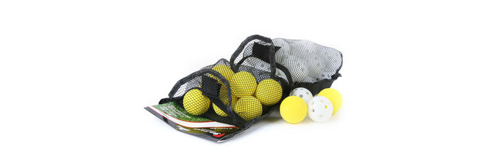 opened Orlimar Practice Golf Balls (36-Pack) on the ground with 2 yellow foam practice golf balls and 2 white plastic golf balls outside of the mesh bag