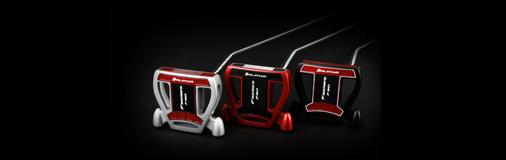 sole view of a silver/red, red/black and a black/red Orlimar F80 putter with their backs resting on the ground