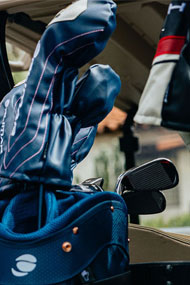 blue Orlimar golf club headcovers on clubs in a blue Orlimar golf bag
