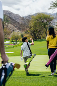 three golfers walking toward the green carrying different colored Orlimar Pitch 'N Putt Sunday bags