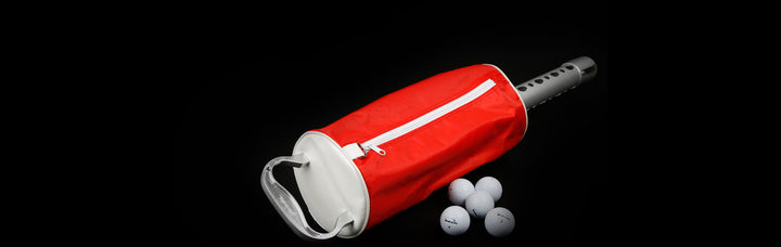 Orlimar Golf Ball Shag Bag lying on the ground with 5 white golf balls next to it