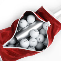 golf balls inside the zippered compartment of a red Orlimar Golf Ball Shag Bag
